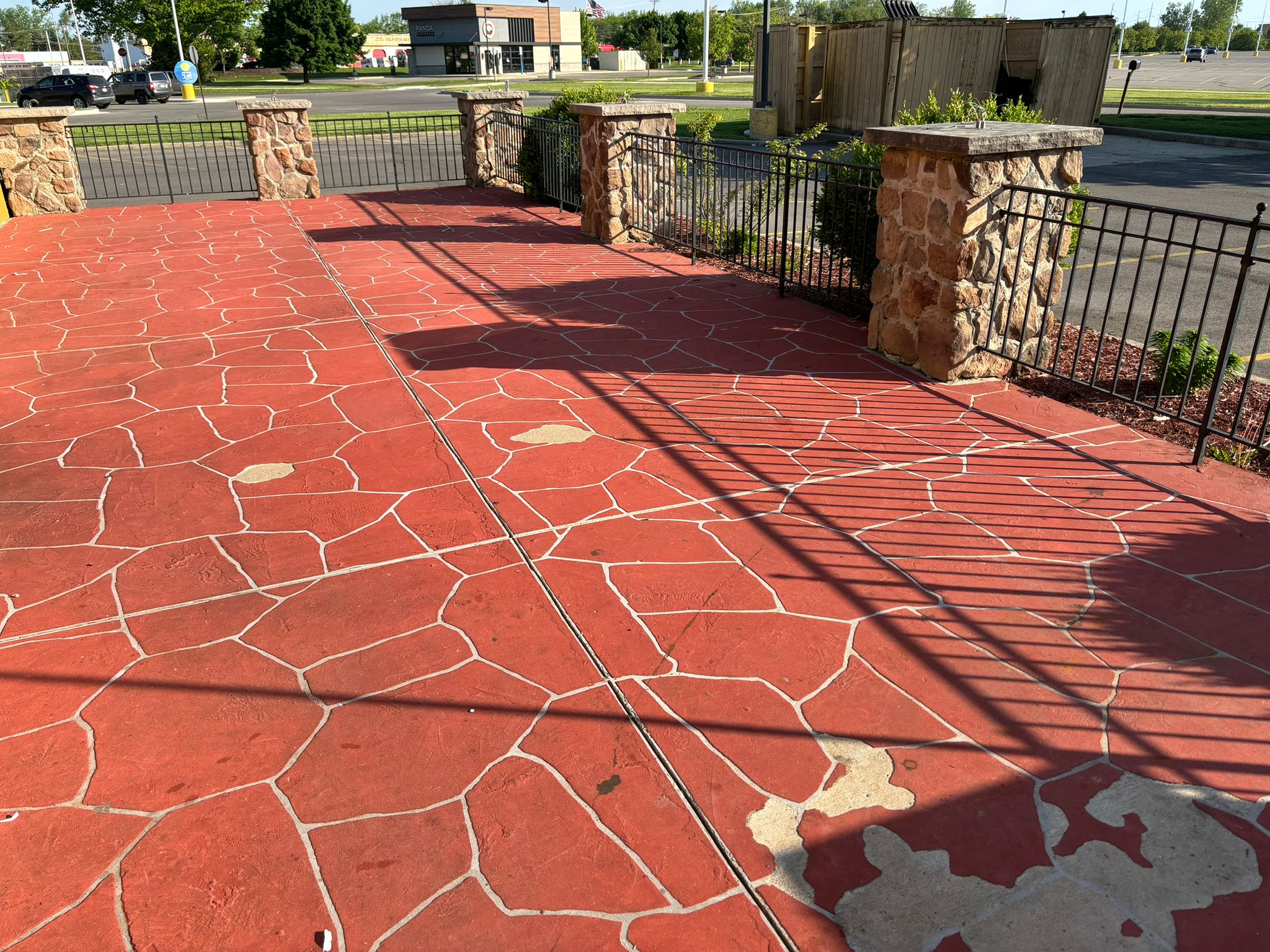 Exposed aggregate decorative patio with stone columns